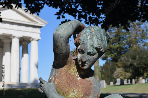 Rusty cemetery statue of a woman