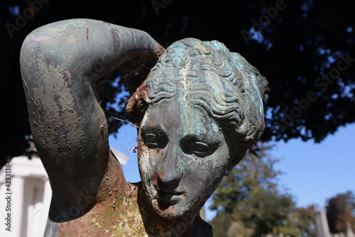 Rusty cemetery statue of a woman