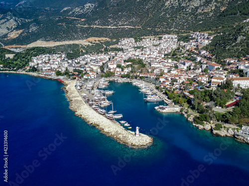 The top view from the drone of Kas resorts and city with amazing blue and clear lagoon and yachts in Mugla province of Turkey