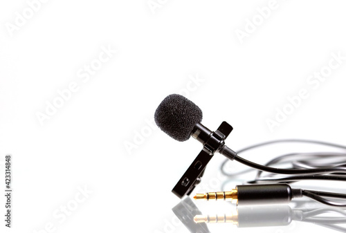 Small lavalier microphone or lapel mic with clip and adapter for computer photo