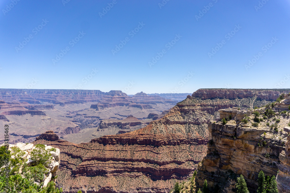 Clear skies and The Grand Canyon. that is a huge valley cut by the Colorado River.