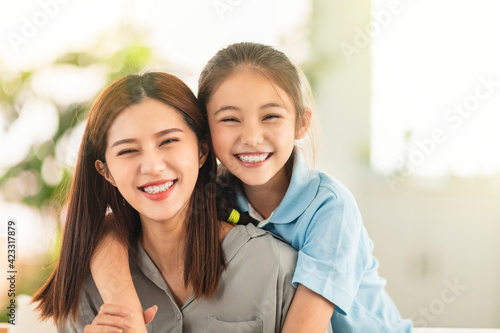 Happy mother and little girl daughter having fun at home