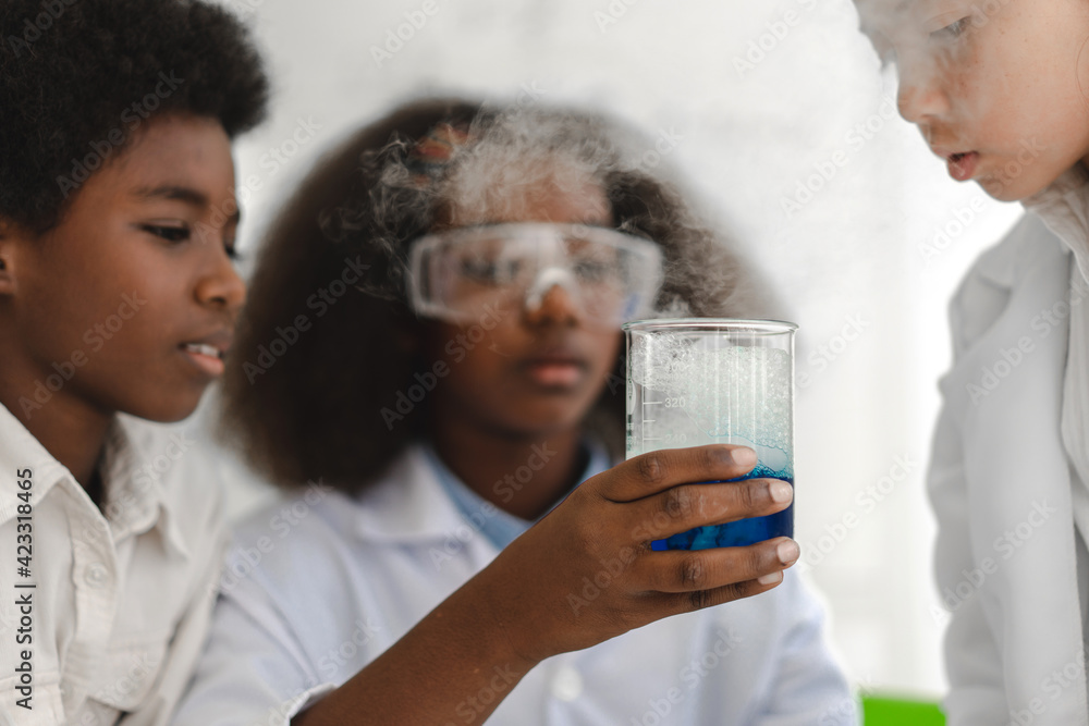 Group of teenage cute little student child learning research and doing a chemical experiment while making analyzing and mixing liquid in test tube at experiment laboratory class at school.Education Group of teenage cute little student child learning research and doing a chemical experiment while making analyzing and mixing liquid in test tube at experiment laboratory class at school.Education