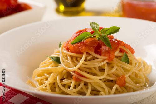 Spaghetti with tomato sauce and basil.