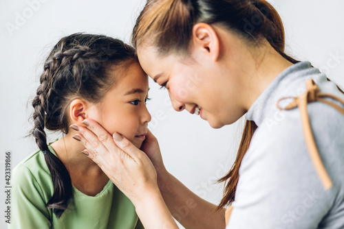 Portrait of enjoy happy love asian family mother and little asian girls child smiling and having fun play with cute kid daughter moments good time