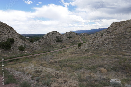 Mountainous natural park area with hiking path trailing off in the distance