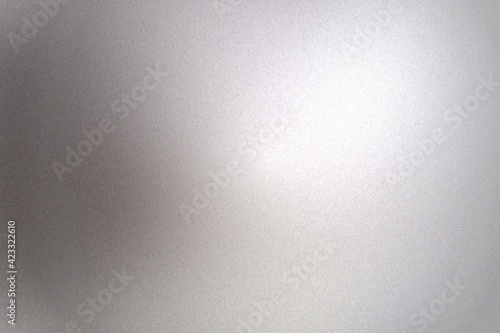 Light shining on gray silver foil glitter metallic wall with copy space, abstract texture background