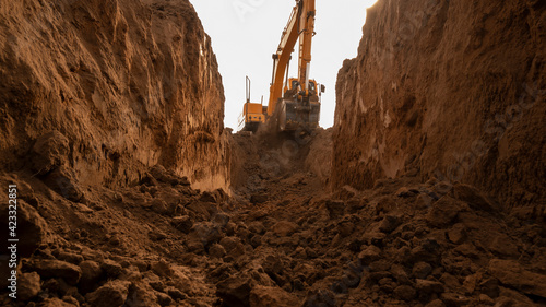 Bild auf Leinwand The excavator digs a trench for laying the pipeline