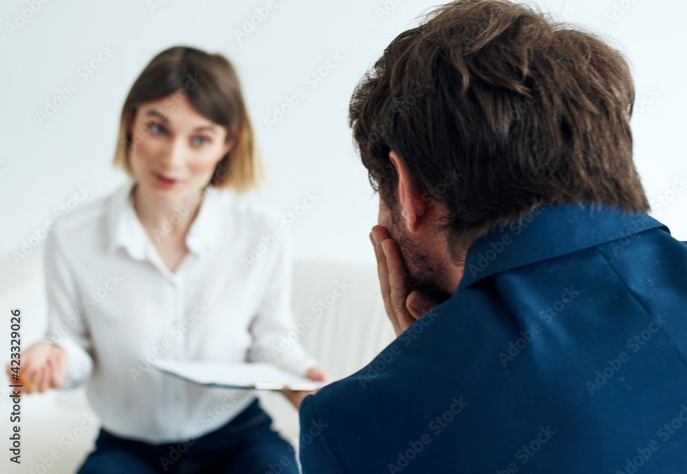 hiring vacancies woman with documents and a man in a suit are sitting on the couch hiring vacancies woman with documents and a man in a suit are sitting on the couch