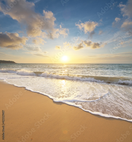 Sandy seashore during sunset.