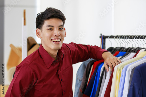 Portrait 1 adult asian handsome man wearing red shirt feel smart happy and confident standing and looking at camera in dressing room