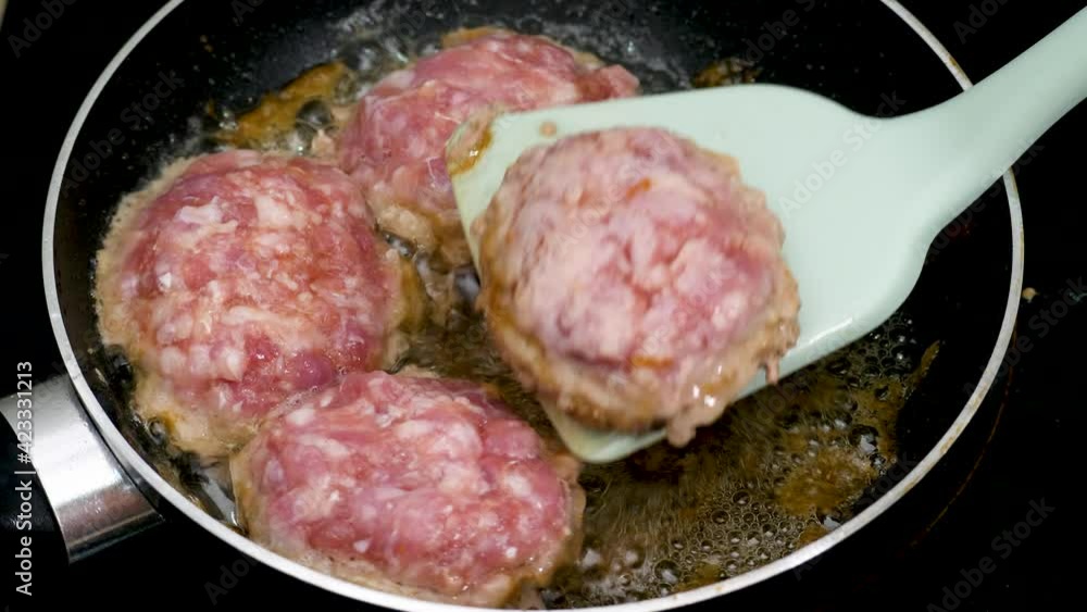 Fry fillet cutlet in pan in home kitchen. Minced meat and spices, raw breaded burger. Food cooking, much fat, delicious frying Fry fillet cutlet in pan in home kitchen. Minced meat and spices, raw breaded burger. Food cooking, much fat, delicious frying