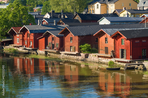 Old red barns on the Porvoonjoki river on a sunny July day. Porvoo city symbol, Finland
