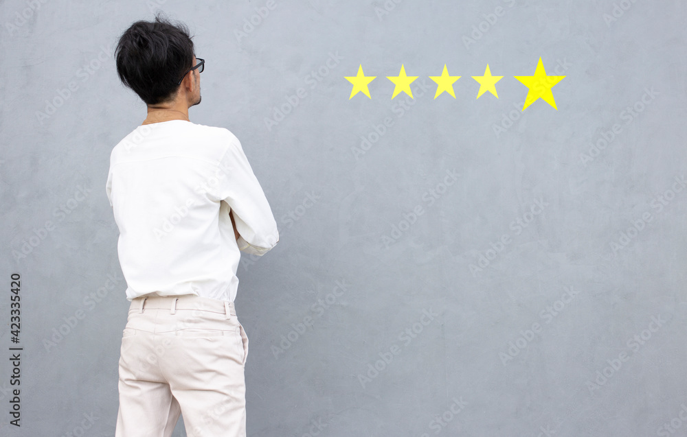 Happy business people looking customer feedback comment with five stars and copy space gray background, Business success concept Happy business people looking customer feedback comment with five stars and copy space gray background, Business success concept