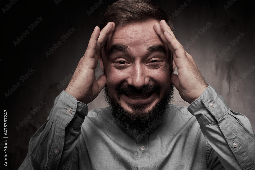 A handsome young man with a beard. The emotions of a man. Depression or hopelessness. Dramatic emotional portrait of a man. High quality photo A handsome young man with a beard. The emotions of a man. Depression or hopelessness. Dramatic emotional portrait of a man. High quality photo