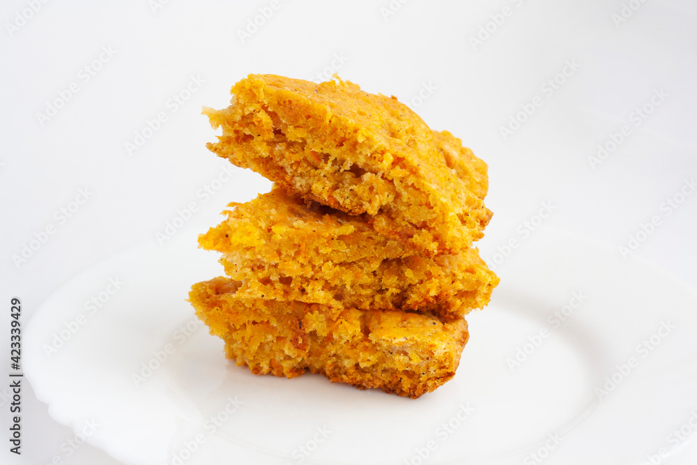 Vegan pastries, carrot cake on a plate on a white background Vegan pastries, carrot cake on a plate on a white background