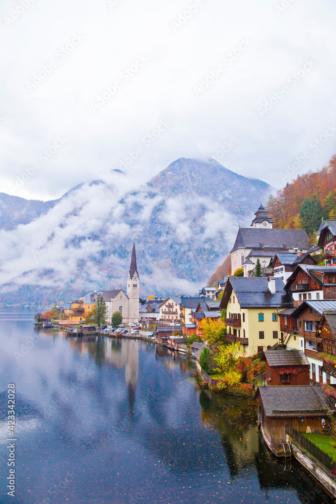Hallstatt town view in a foggy day and clouds between the mountains, Austria.