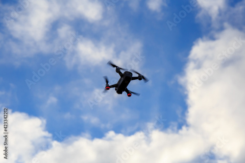 Drone fly with the blue sky and white clouds.