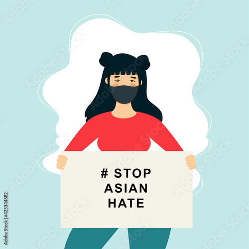 Stop Asian Hate‬‬. Hashtag to support asian community during the covid-19 pandemic. Stop racism. woman wearing protective face mask and holding banner against bullying, hate and violence.