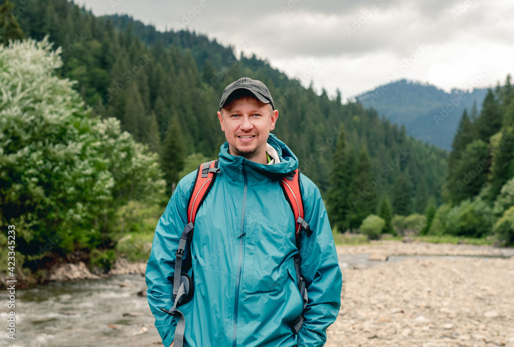Young tourist standing on mountain background Young tourist standing on mountain background