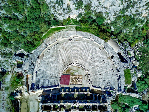 High angle drone aerial view of ancient greek rock cut lykian empire amphitheatre and tombs in Myra (Demre, Turkey) photo