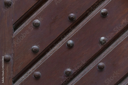 wooden background with iron rivets sloping stripes dark brown