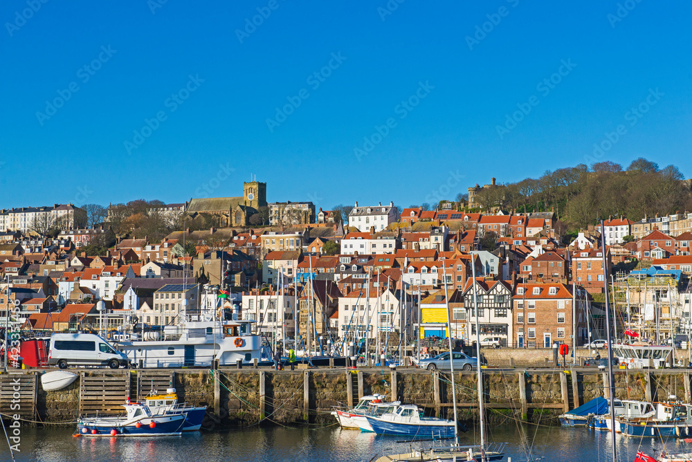 Harbor seafront town with medieval church on hill