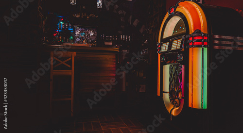 Retro jukebox on dark background in bar photo