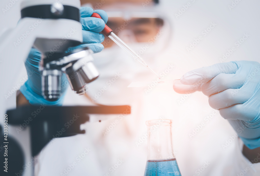 biochemical research scientist working with microscope for coronavirus, laboratory glassware containing chemical liquid for design or decorate science, chemistry, biology, medicine and people concept biochemical research scientist working with microscope for coronavirus, laboratory glassware containing chemical liquid for design or decorate science, chemistry, biology, medicine and people concept
