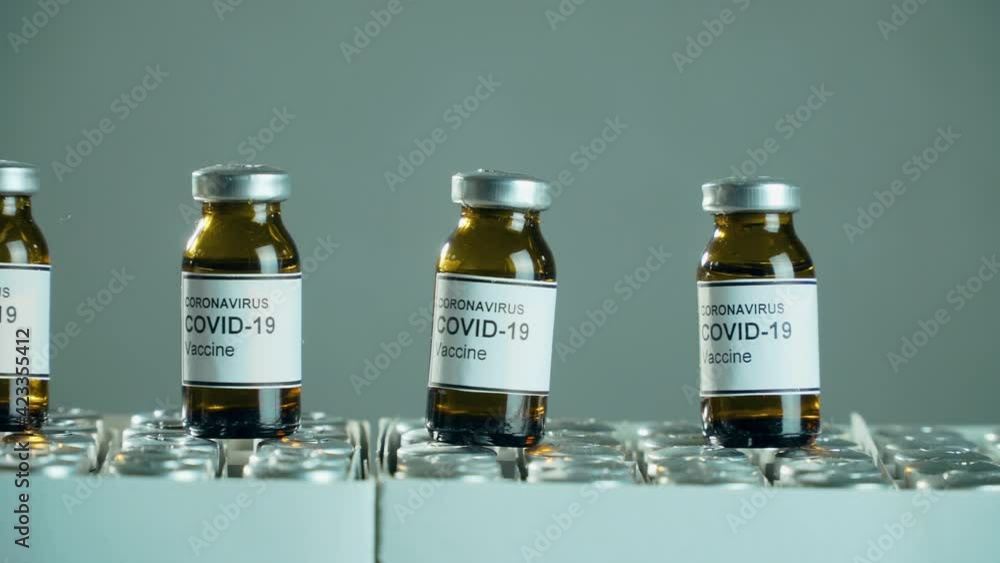 Coronavirus vaccine bottles in pharmaceutical industry. Medicines research concept and defeating dangerous covid-19 infection Coronavirus vaccine bottles in pharmaceutical industry. Medicines research concept and defeating dangerous covid-19 infection