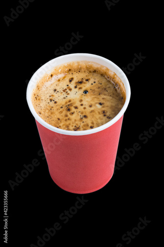 Coffee to go in a paper cup without a lid on a black background copy space top and side view