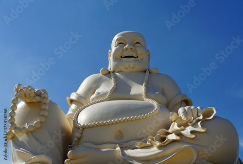 Giant Buddha statue agains a bright blue sky in Vietnam