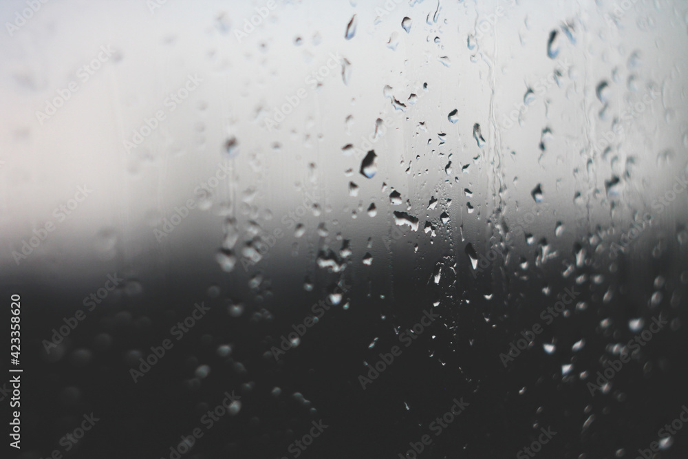 Raindrops on glass embodying sadness and grief in black and white Raindrops on glass embodying sadness and grief in black and white