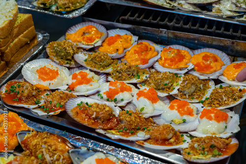 Close up of a colorful Grilled Scallops with Cheese and Garlic Butter.