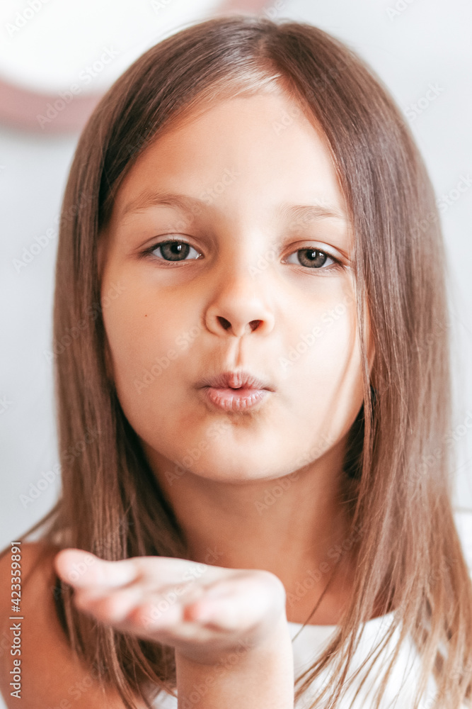 Little girl sends an air kiss. Close-up portrait Little girl sends an air kiss. Close-up portrait