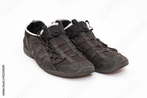 Mens old black sneakers on a white background