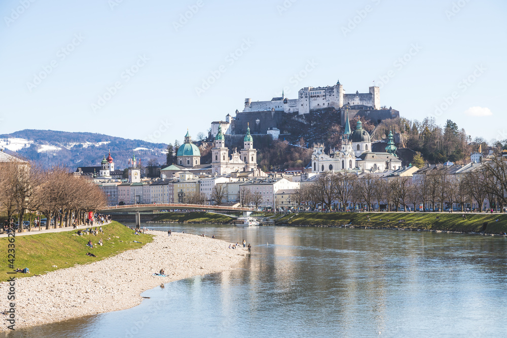 Salzburg spring time: Panoramic city landscape with Salzach with green grass and historic district