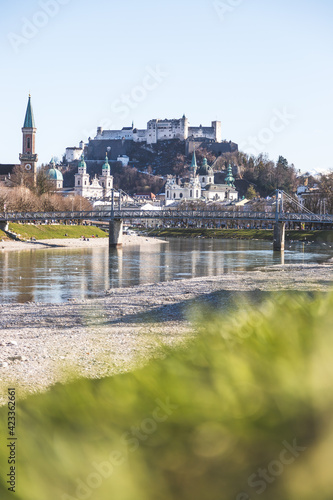 Salzburg spring time: Panoramic city landscape with Salzach with green grass and historic district