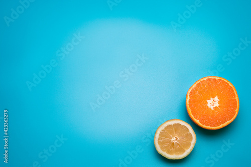 Fruits on the blue background. Orange  lemon. Free space for text.