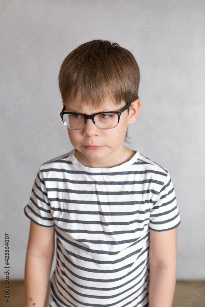 Fototapeta premium Upset and angry boy concept for anger, frustration and mischief with copy space