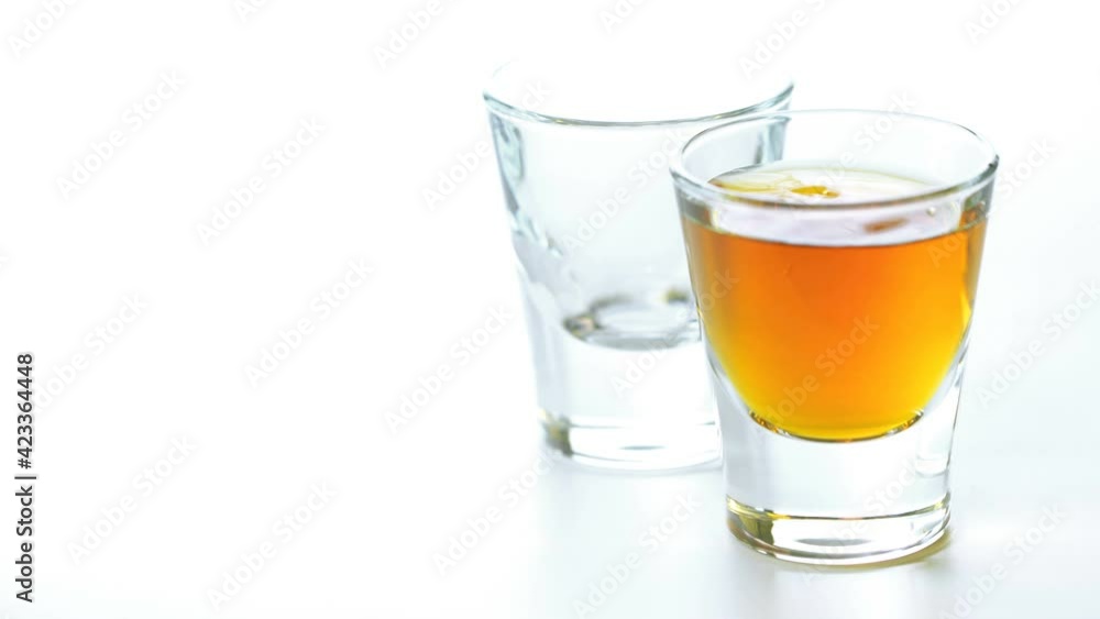 whiskey is poured into a glass from bottle whiskey is poured into a glass from bottle