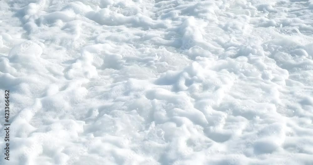 Big waves on the sea shore full of pebbles stones. Foam from the strong water Big waves on the sea shore full of pebbles stones. Foam from the strong water