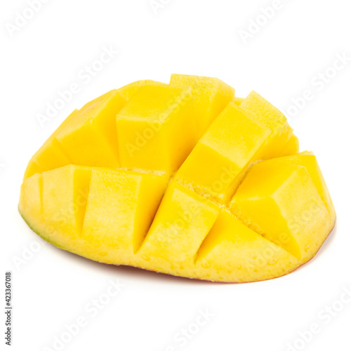 Closeup ripe mango fruit slice with green leaves isolated on white