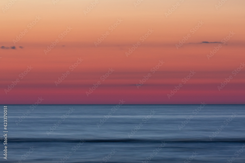 Colorful evening sky and blue sea, long exposure shot