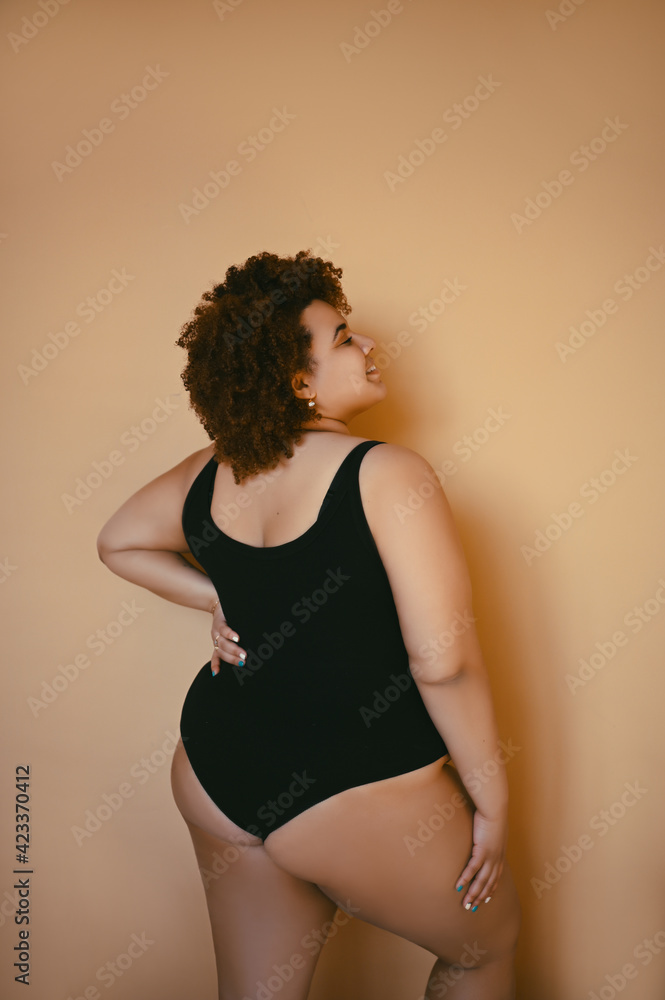 Beautiful curvy oversize African black woman afro hair posing in
