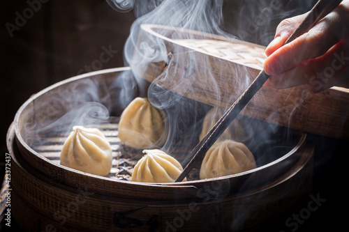 Chinese dumplings in wooden steamer. Old Chinese cuisine.