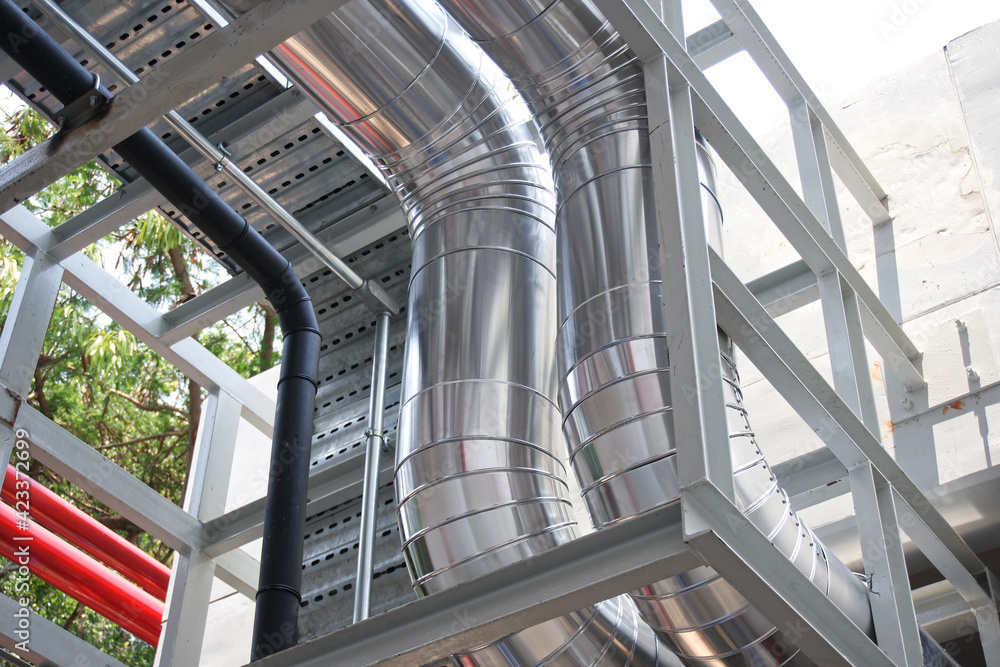 Fototapeta premium Chilled water system pipes with insulation and cladding it with a roll of aluminum sheet.