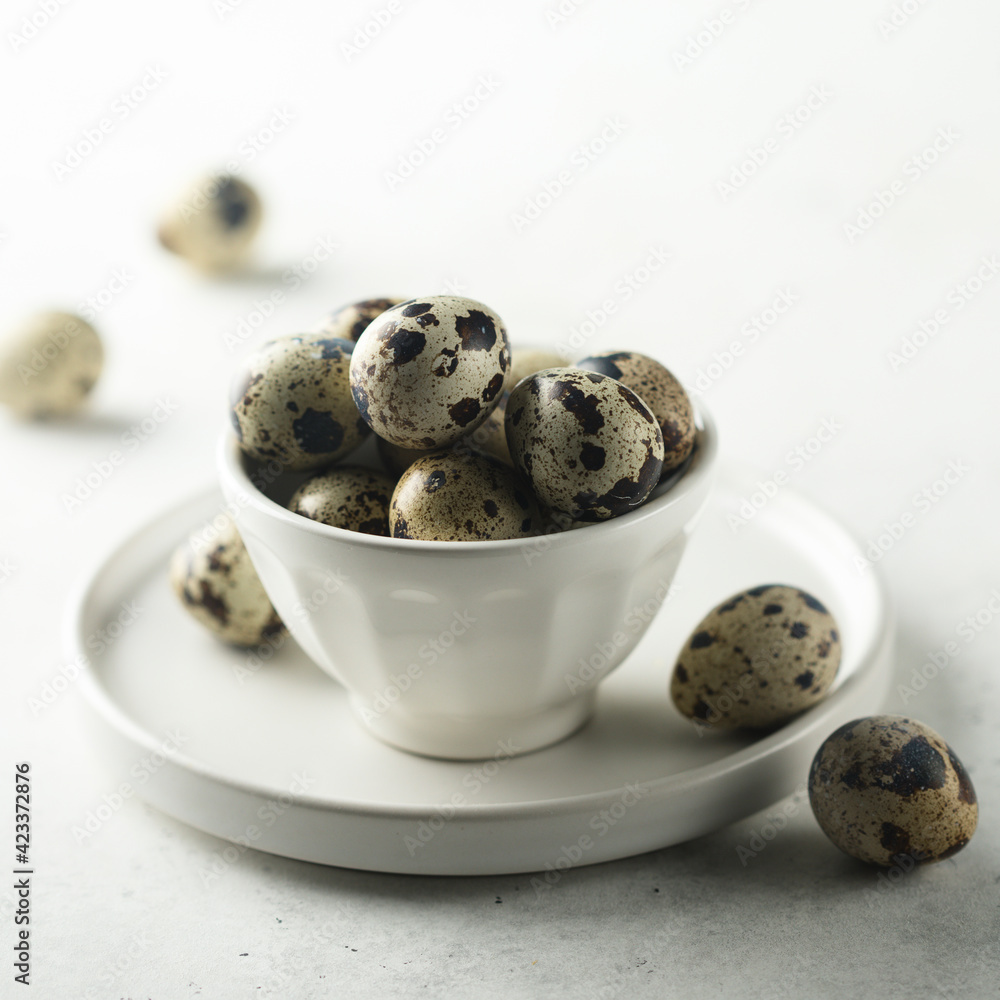 Healthy organic quail eggs in a white bowl Healthy organic quail eggs in a white bowl