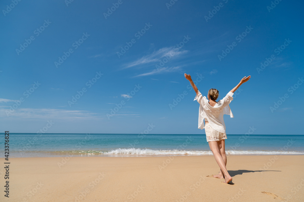 Happy young woman enjoying freedom with open hands on sea. Happy young woman enjoying freedom with open hands on sea.