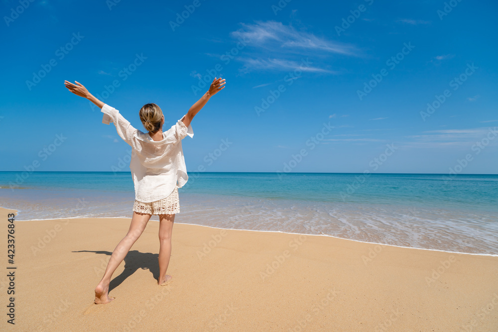 Happy young woman enjoying freedom with open hands on sea. Happy young woman enjoying freedom with open hands on sea.